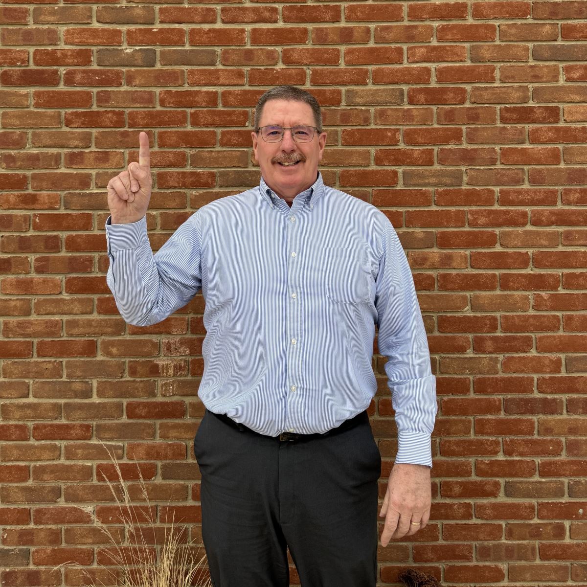 Brian holding up a one with his finger.