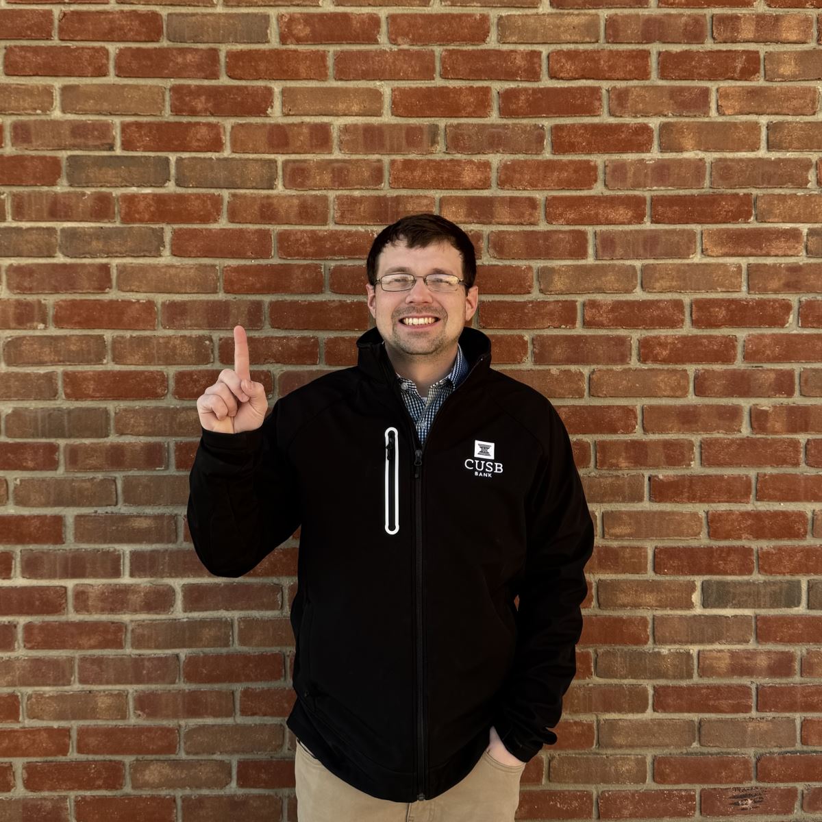 Cody holding up a one with his finger.