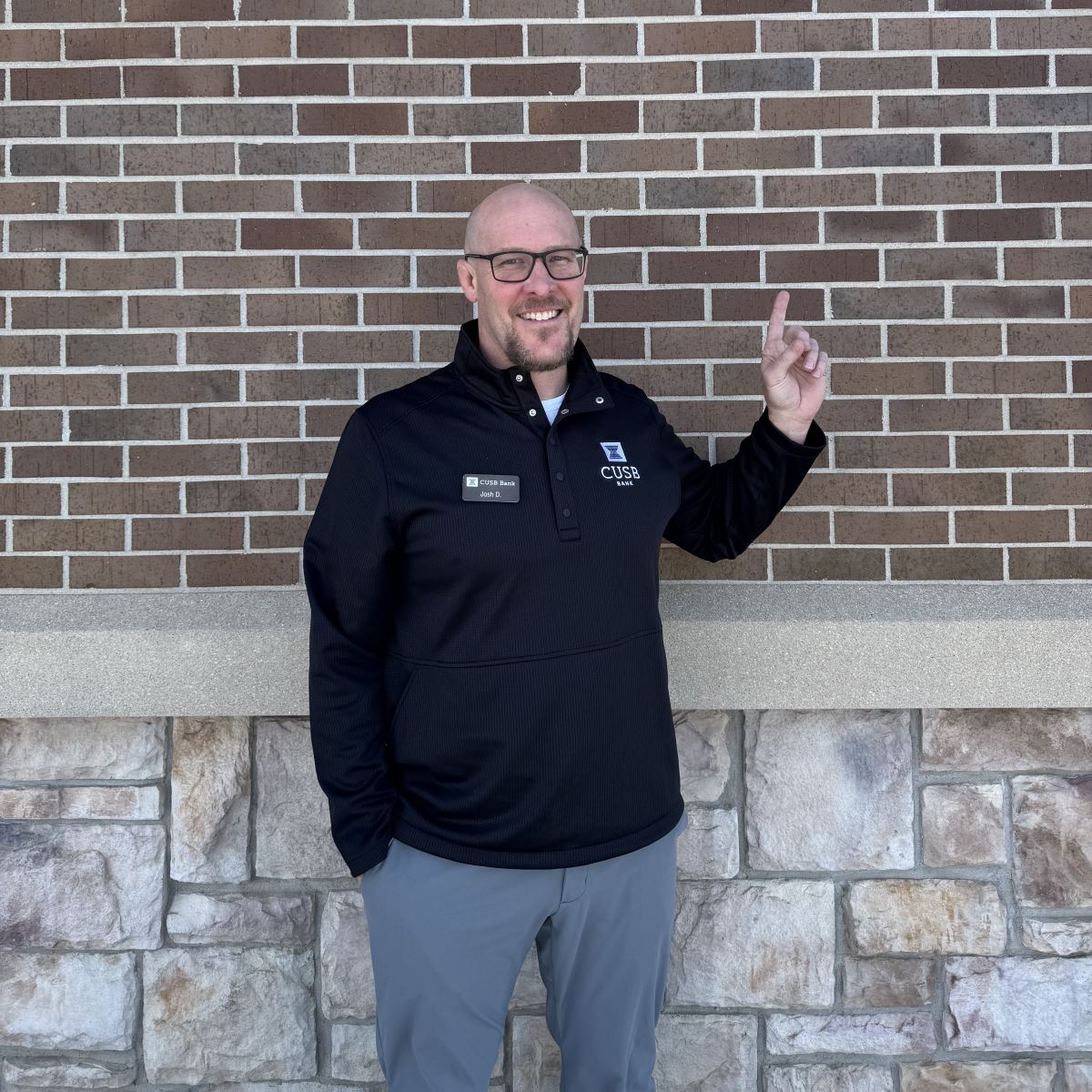 Josh holding up a one with his finger.