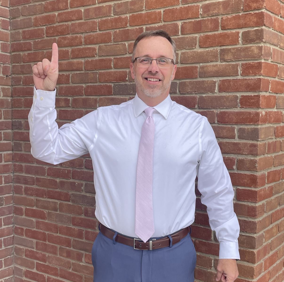 Kevin holding up a one with his finger.