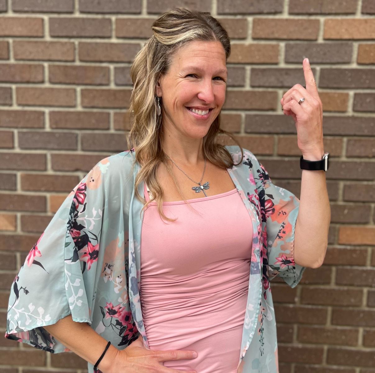 Stacy holding up a one with her finger.